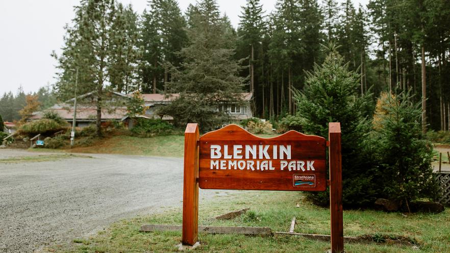 Blenkin Memorial Park entrance sign with trees in the background.