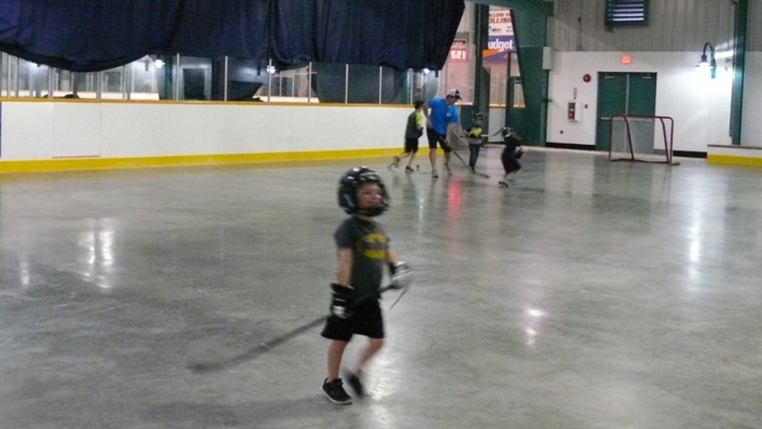 Kids ages 3 to 5 playing floor hockey on the Leisure dry floor