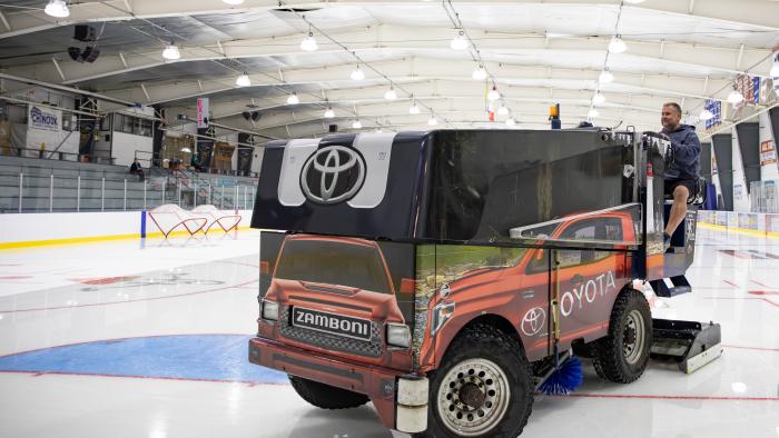 Operations staff driving zamboni on the ice