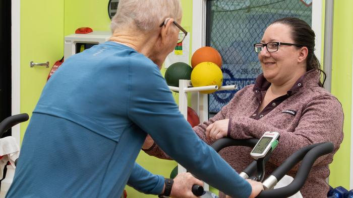 Staff monitoring a patron in the take heart program