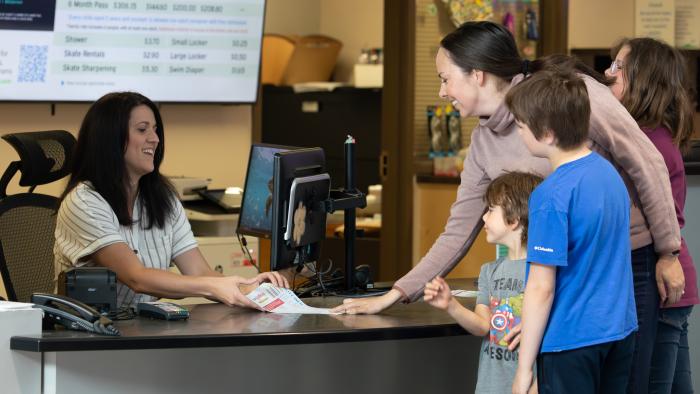 Reception staff helping a customer
