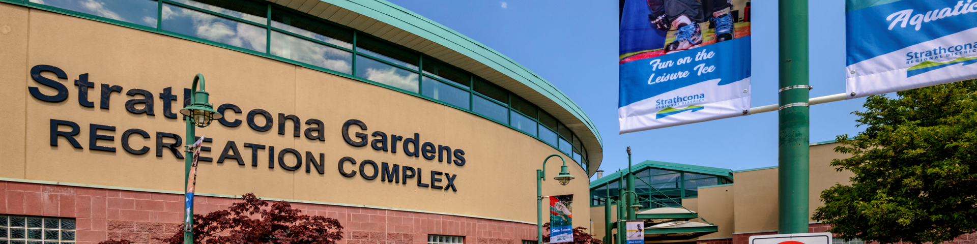 Strathcona Gardens Recreation Complex exterior with blue sky and lamppost banners.