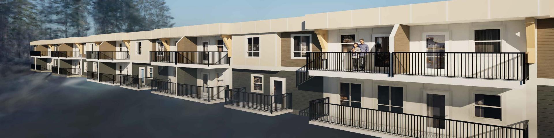 A modern low-rise building with balconies, surrounded by trees and a clear sky.