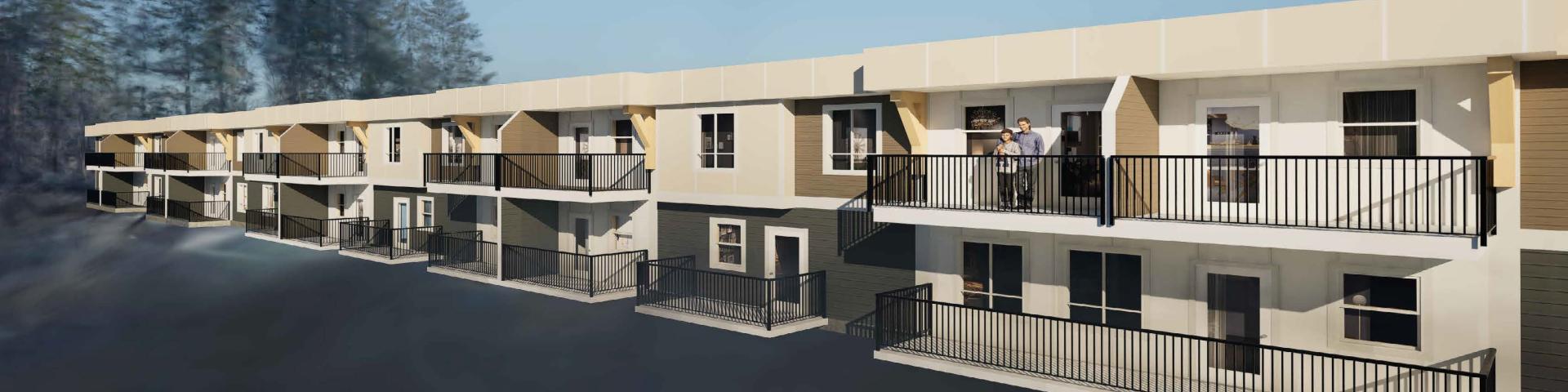 Newly constructed apartment building with balconies and trees in the background.