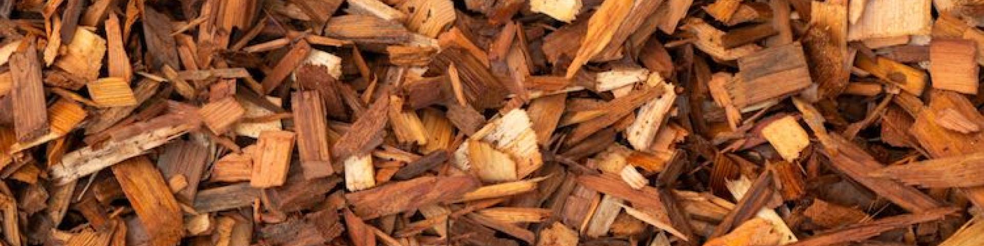 A close-up of finely shredded wood mulch in various shades of brown.